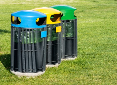 Community event setup with waste bins and recycling stations.